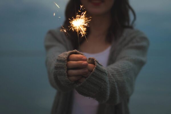 Two hands holding a sparkler